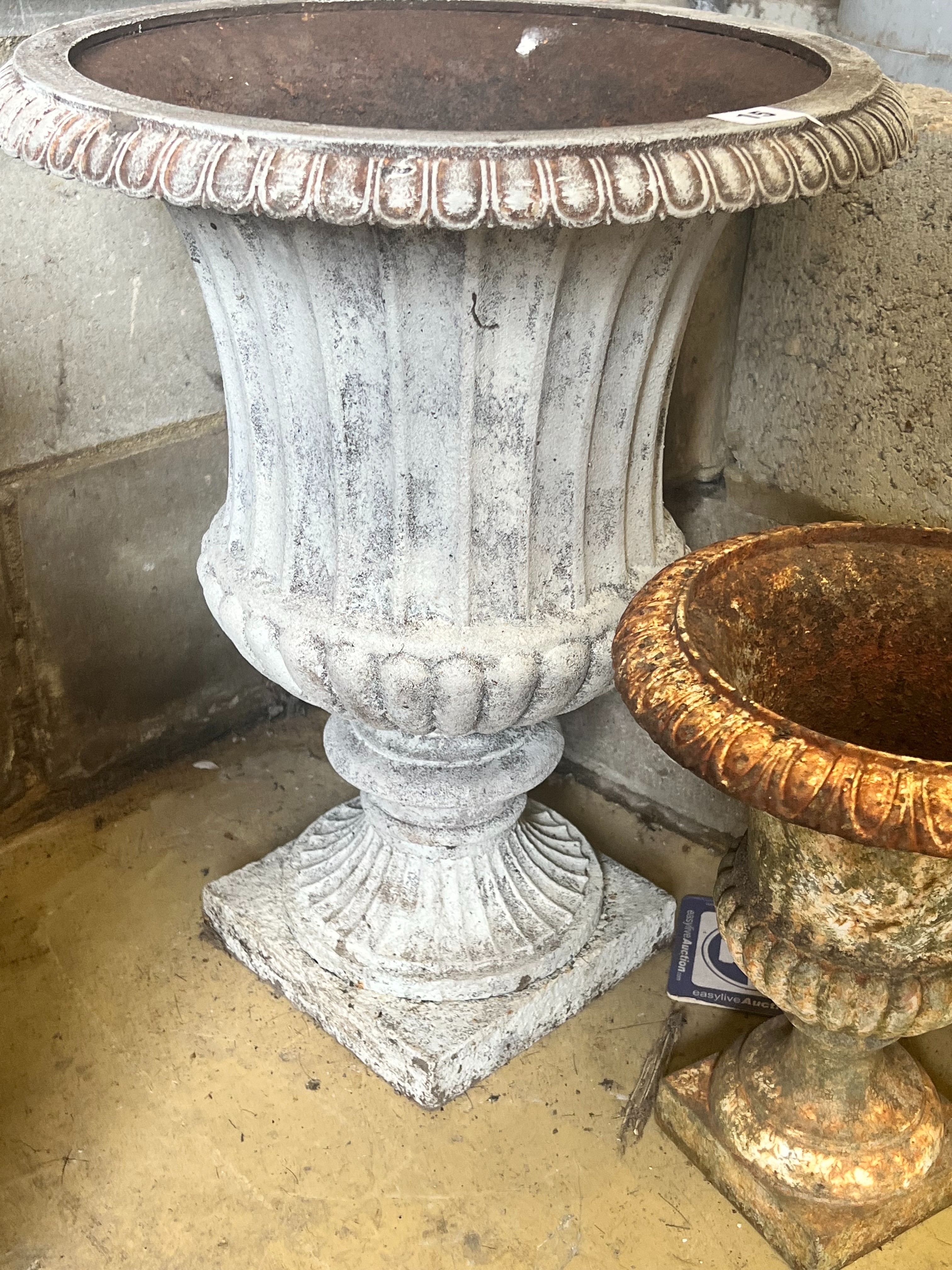 A pair of cast iron campana garden urns, larger diameter 39cm height 48cm